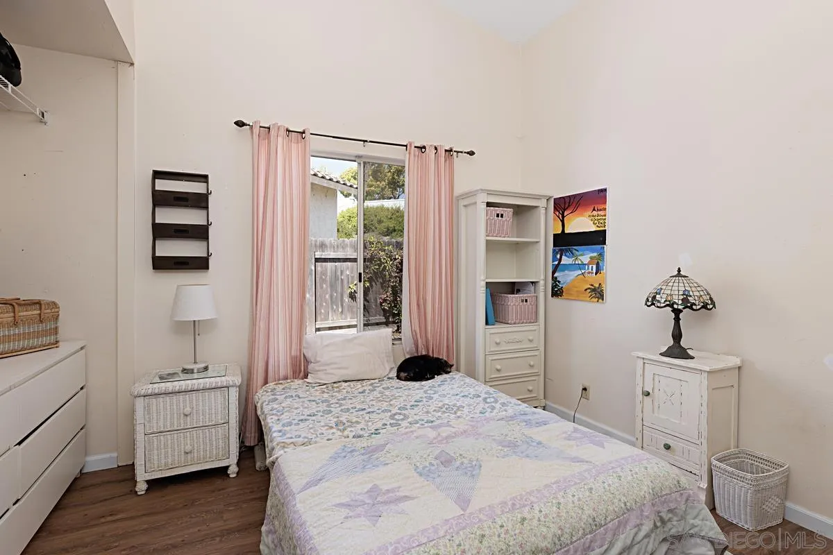 1505 Avenida Oceano Oceanside, CA 92056 - Photo 20 of 26 a bedroom with a bed and wooden floor