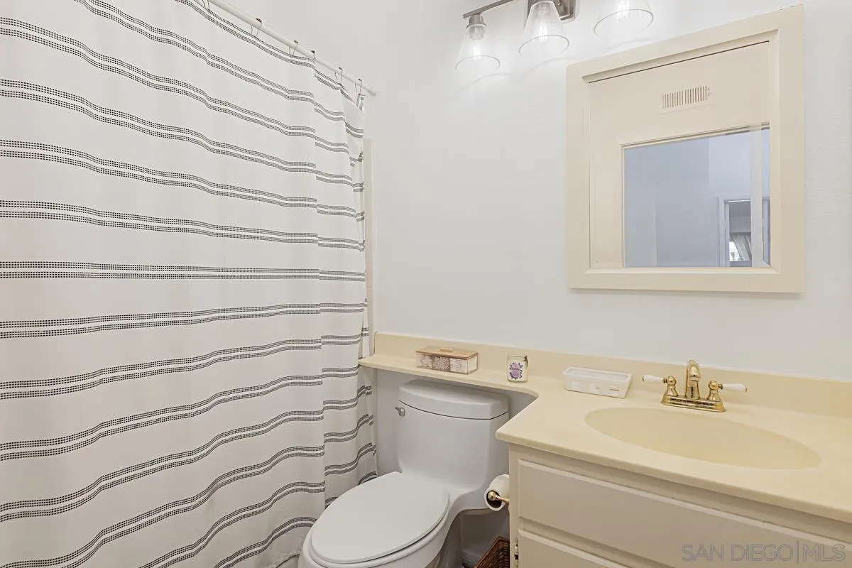1505 Avenida Oceano Oceanside, CA 92056 - Photo 21 of 26 a bathroom with a sink a toilet and a mirror