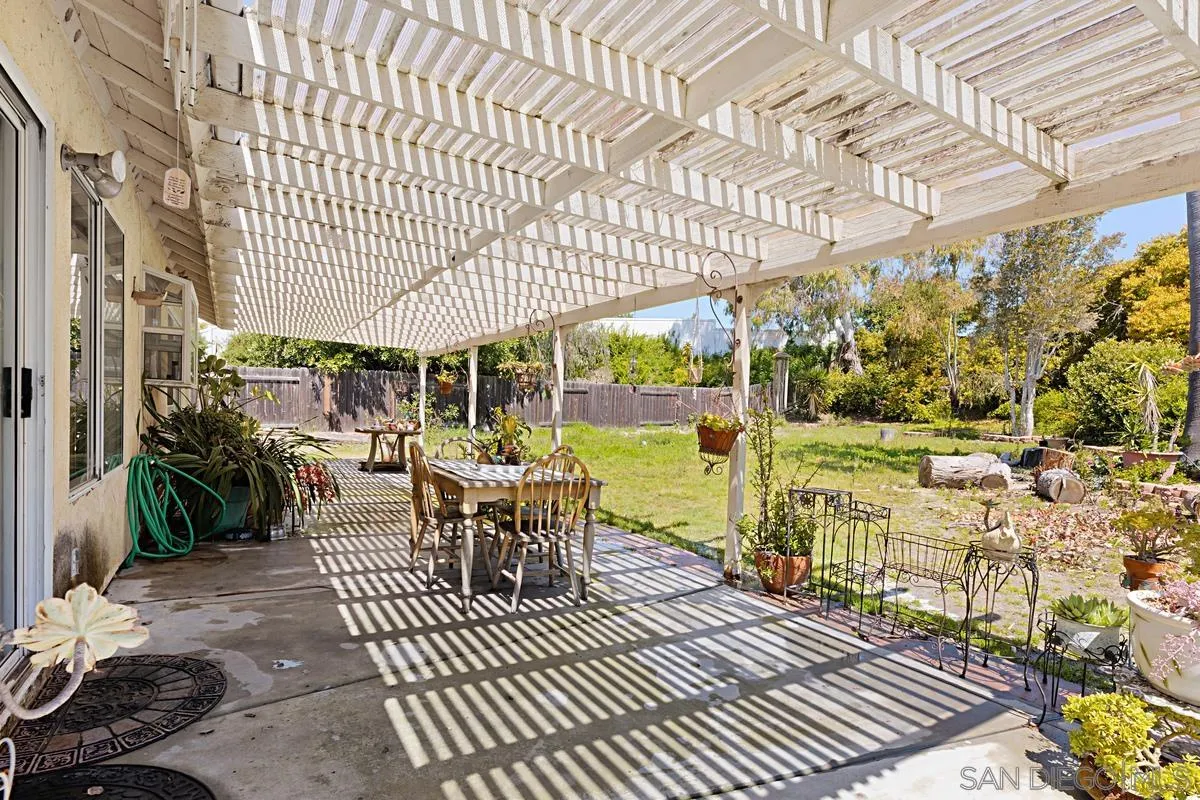 1505 Avenida Oceano Oceanside, CA 92056 - Photo 22 of 26 a view of a patio with a dining table and chairs with wooden floor