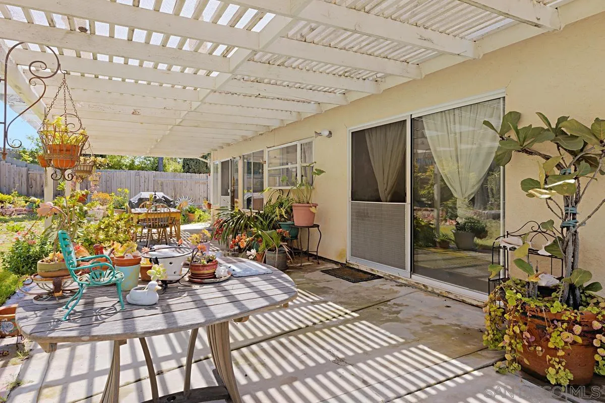 1505 Avenida Oceano Oceanside, CA 92056 - Photo 23 of 26 a view of a porch with a table and chairs and potted plants