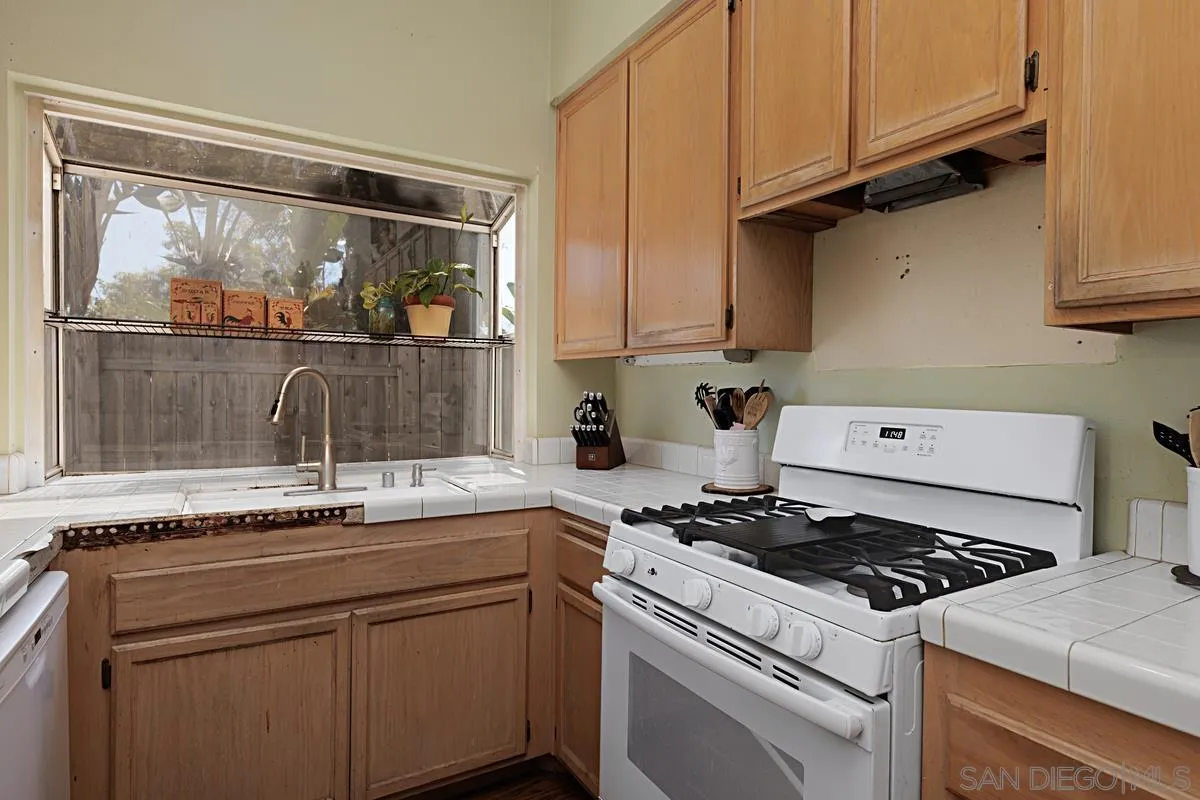 1505 Avenida Oceano Oceanside, CA 92056 - Photo 10 of 26 a kitchen with a sink and a stove top oven