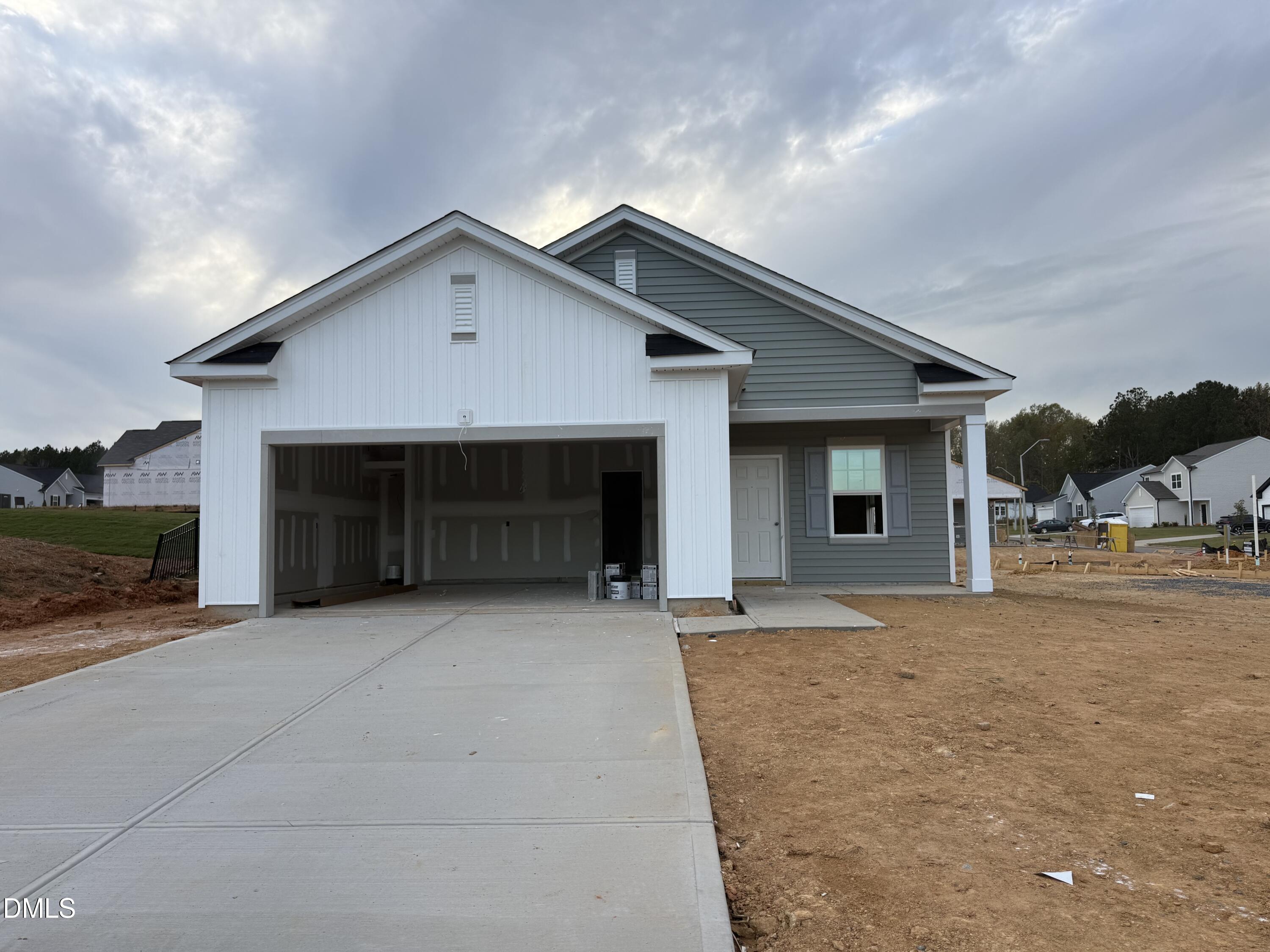 a view of a house with a yard and garage