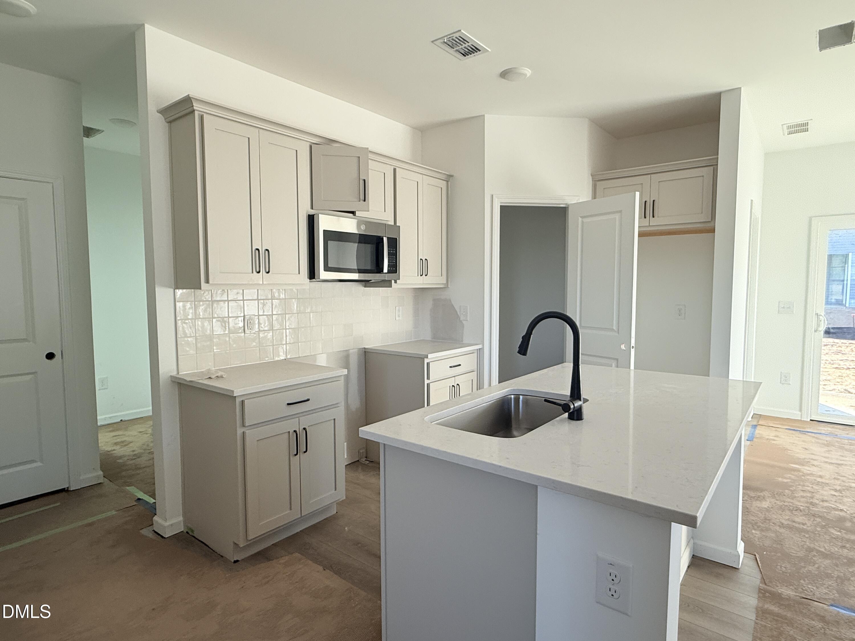 6726 Jersey Road Middlesex, NC 27557 - Photo 2 of 23 a kitchen with sink a microwave and cabinets