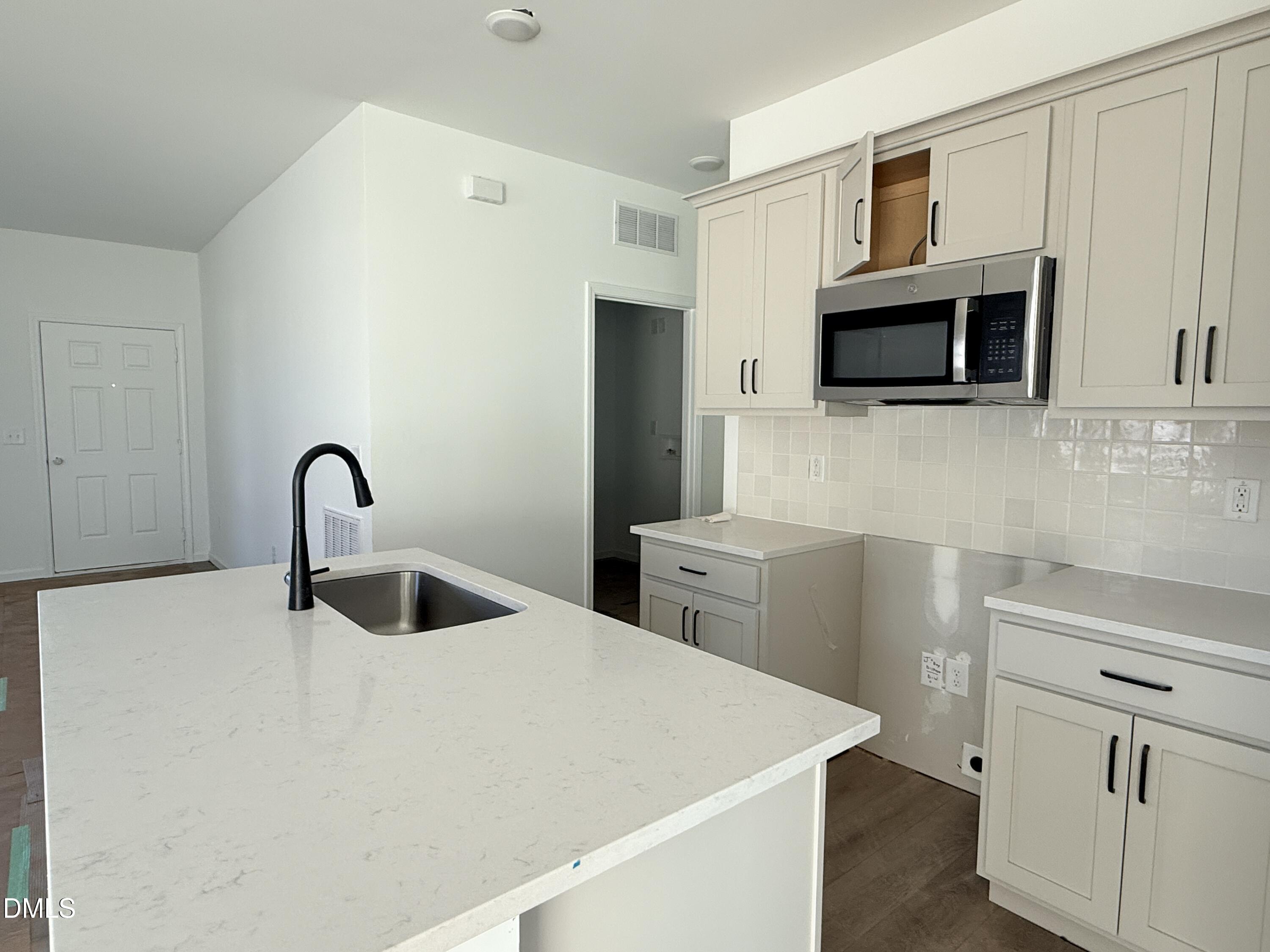 6726 Jersey Road Middlesex, NC 27557 - Photo 3 of 23 a close view of a sink and a stove in a kitchen
