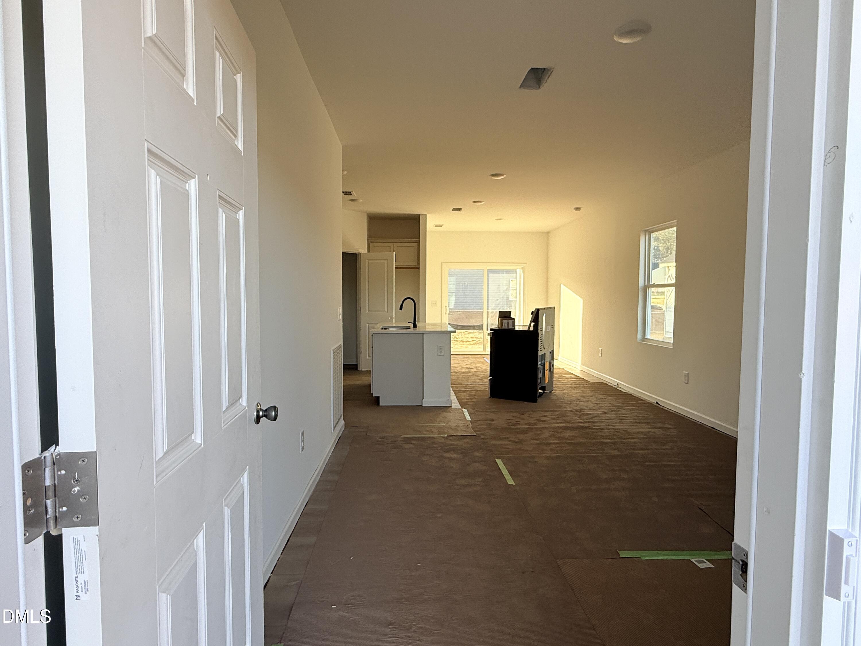 6726 Jersey Road Middlesex, NC 27557 - Photo 5 of 23 a view of a hallway with a dining table and chairs