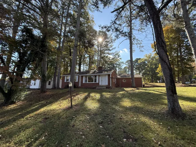 a view of a house with yard and tree s