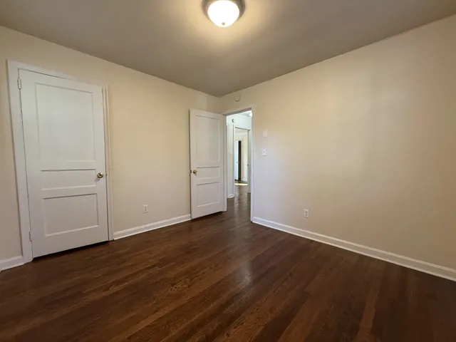 a view of an empty room and wooden floor