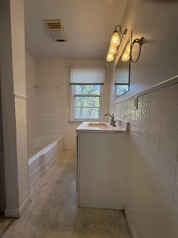 a bathroom with a sink a mirror and a shower