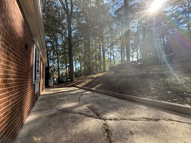 a view of a street with trees and bushes