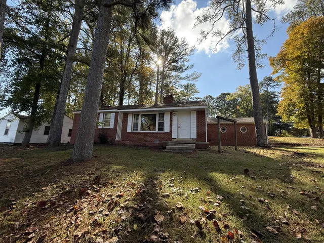 a view of a yard with a house and a tree