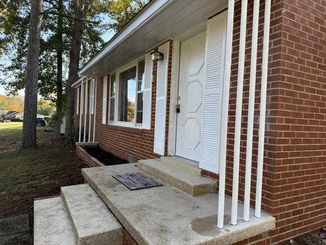 a view of wooden house with a yard