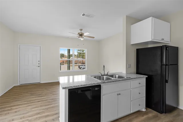 a kitchen with a sink and refrigerator