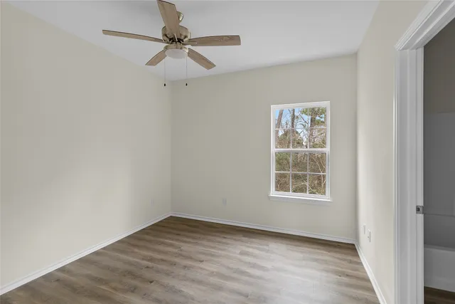 wooden floor in an empty room with a window