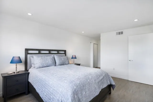 a bedroom with a bed and a night stand