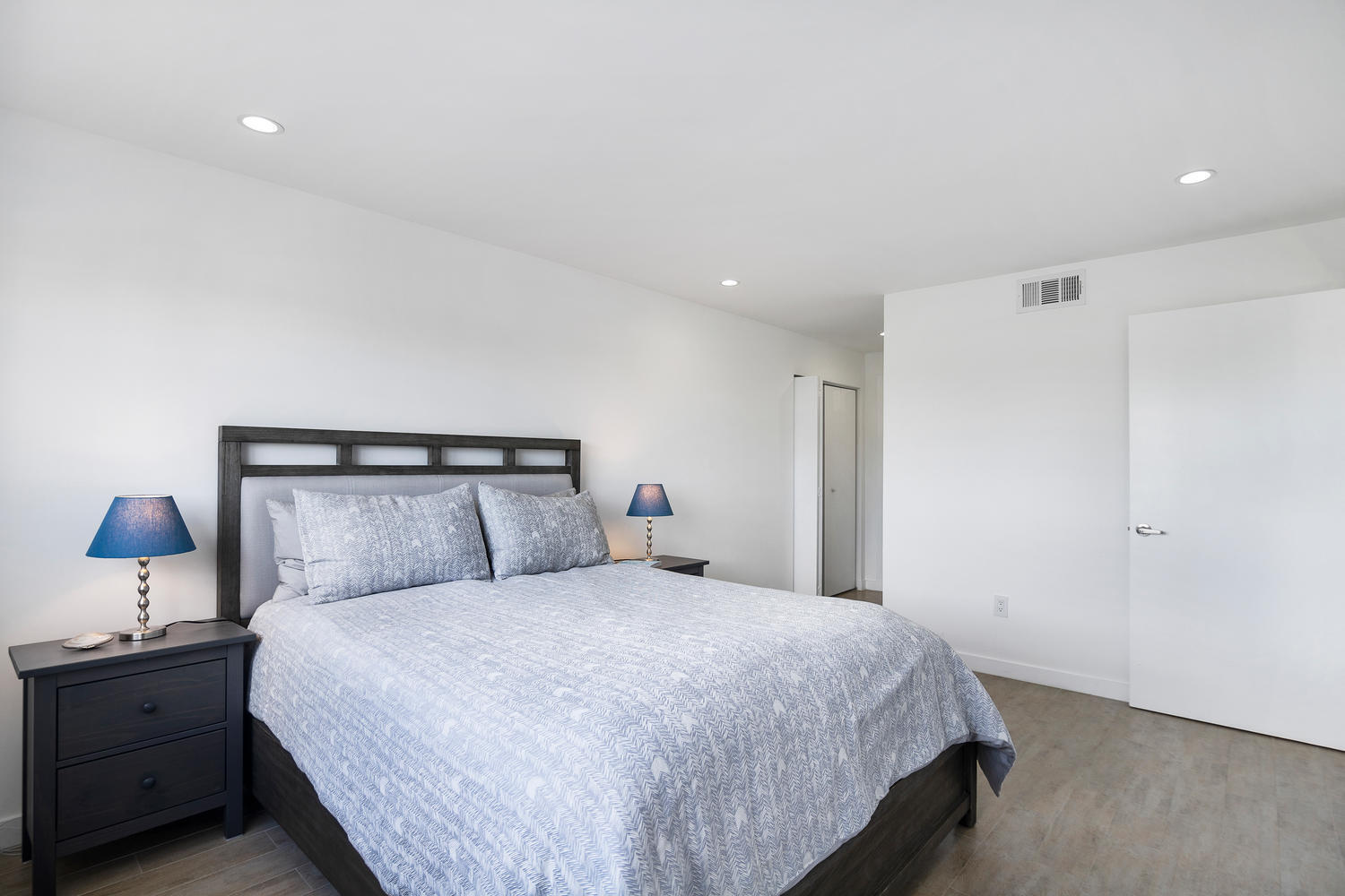 1605 Pennsylvania Avenue, Unit 502 Miami Beach, FL 33139 - Photo 14 of 21 a bedroom with a bed and a night stand