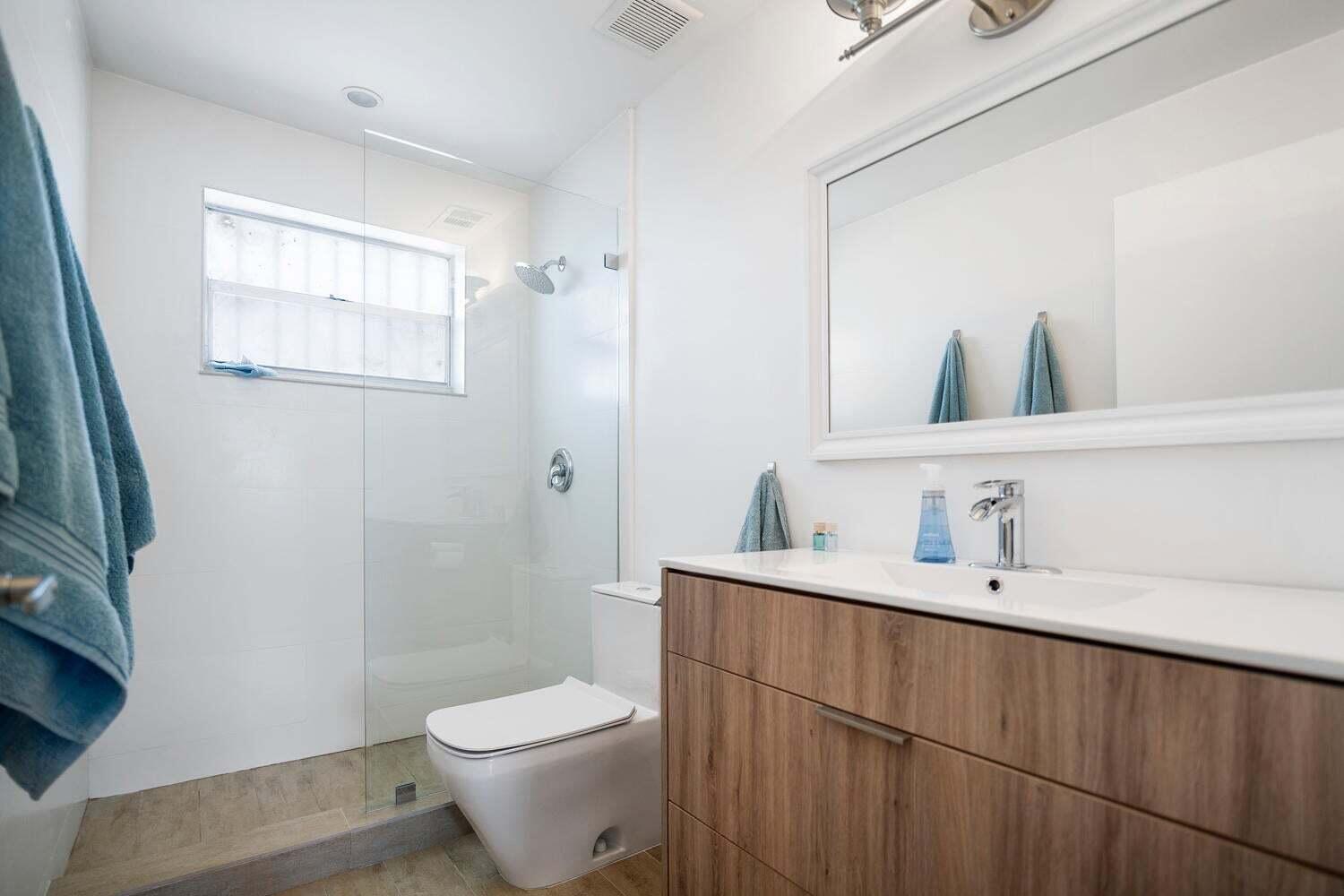 1605 Pennsylvania Avenue, Unit 502 Miami Beach, FL 33139 - Photo 15 of 21 a bathroom with a toilet a sink a mirror and vanity