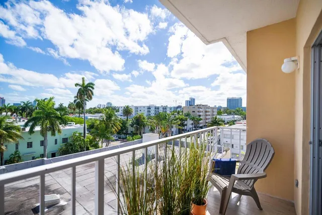 a view of a chair and table in patio