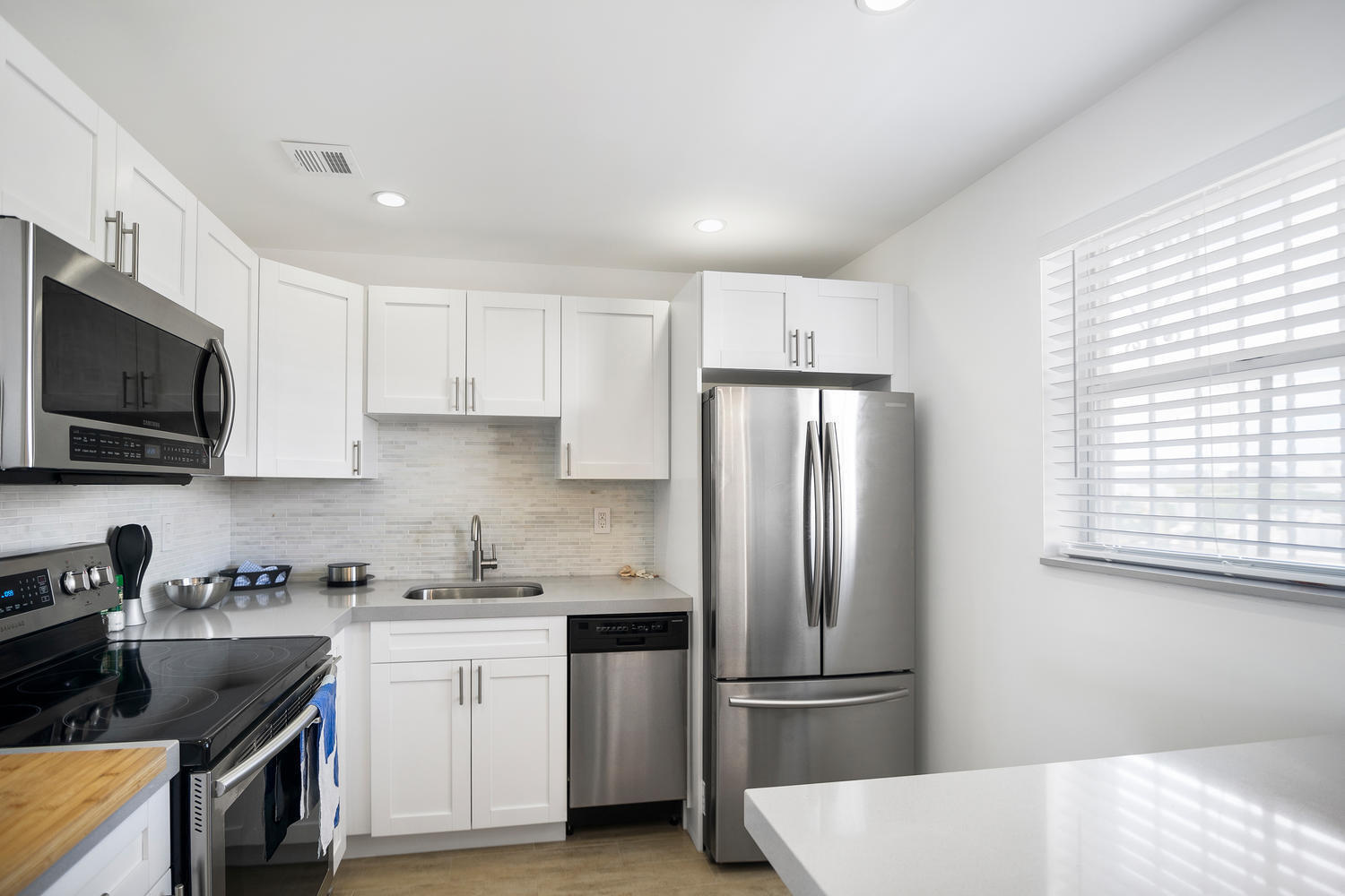 1605 Pennsylvania Avenue, Unit 502 Miami Beach, FL 33139 - Photo 9 of 21 a kitchen with stainless steel appliances granite countertop a refrigerator sink and microwave