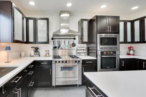 a kitchen with stainless steel appliances a stove a sink and a refrigerator