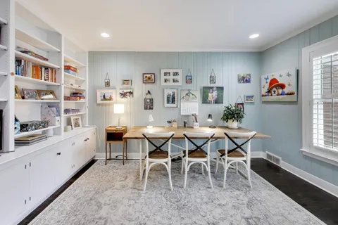 a dining room with furniture and window