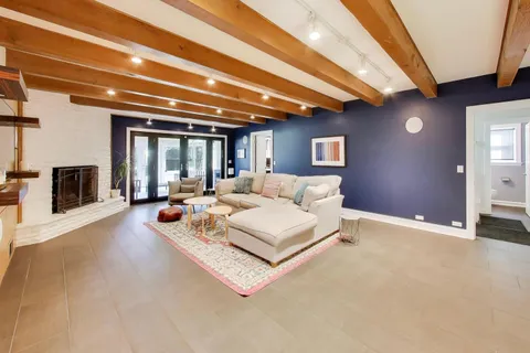 a living room with furniture and a chandelier