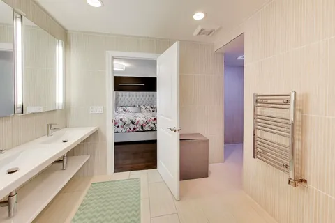 a bathroom with a bathtub sink and mirror