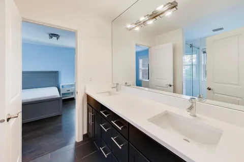 a bathroom with a sink double vanity and a mirror