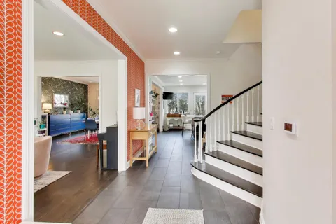 a view of entryway and hall with dining room