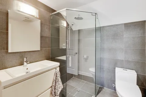 a bathroom with a toilet sink and shower