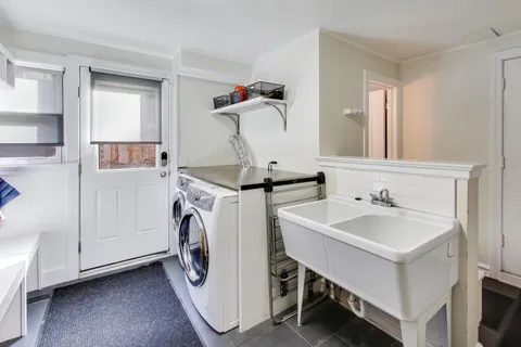 a utility room with cabinets dryer and washer