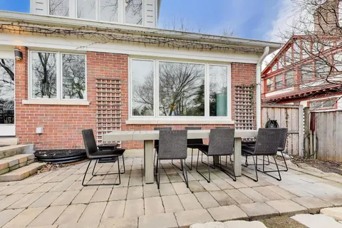 a building outdoor space with patio furniture and potted plants