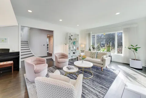 a living room with furniture and a piano