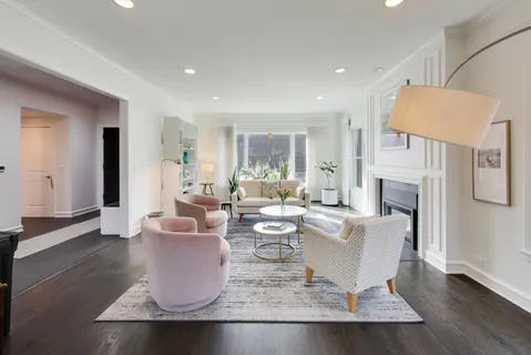 a living room with fireplace furniture and a wooden floor