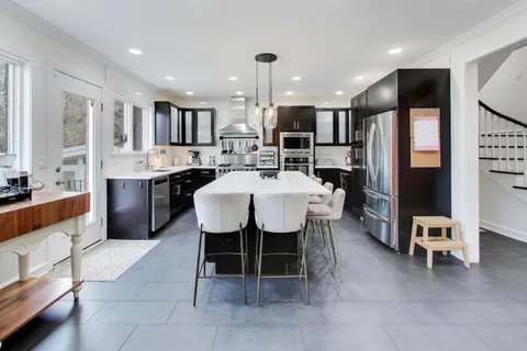 a large kitchen with a table and chairs