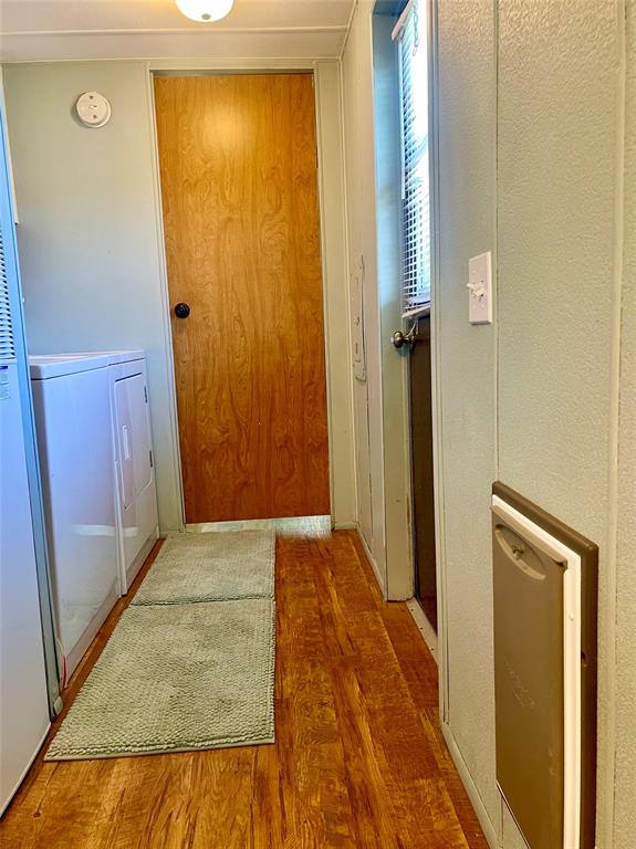 2334 San Bar Road, Unit 96 Graford, TX 76449 - Photo 12 of 40 Situated out of the way in the hall is where you'll find the full-size washer & dryer, exit to the back of the property, the doggy door to the fenced side yard, and a door to close off the 2nd bedroom and bathroom.