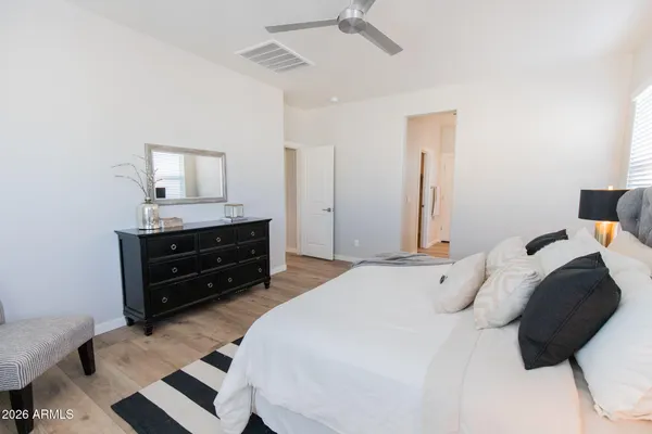 a bedroom with a bed and a chandelier