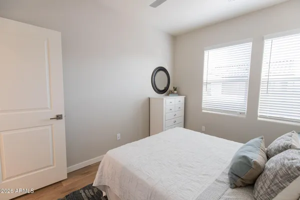 a bedroom with a bed and a painting on the wall