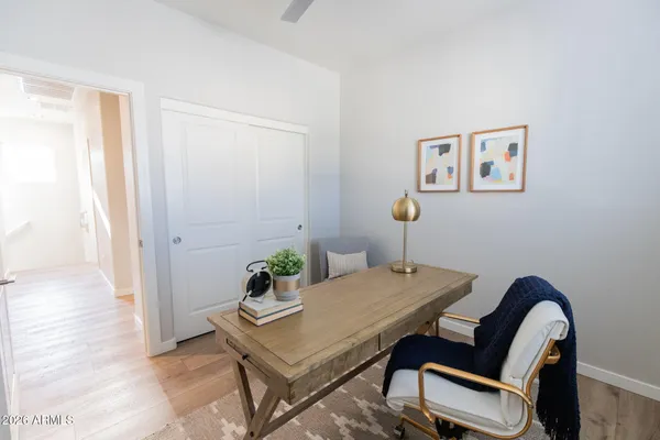 a view of a workspace with furniture and a window