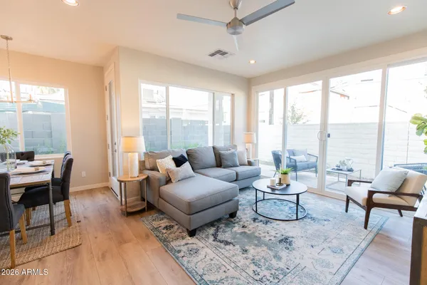 a open dining room with stainless steel appliances kitchen island granite countertop furniture and a kitchen view
