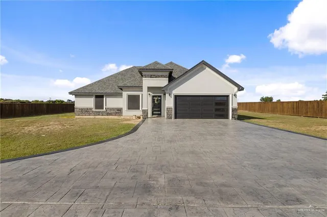 a view of house with yard and ocean view