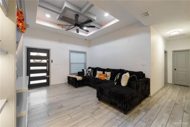 a living room with furniture and a wooden floor
