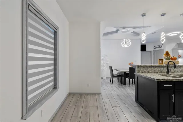 a view of a room with furniture and wooden floor