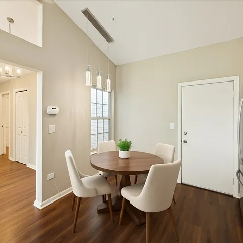 a view of a dining room with furniture and wooden floor