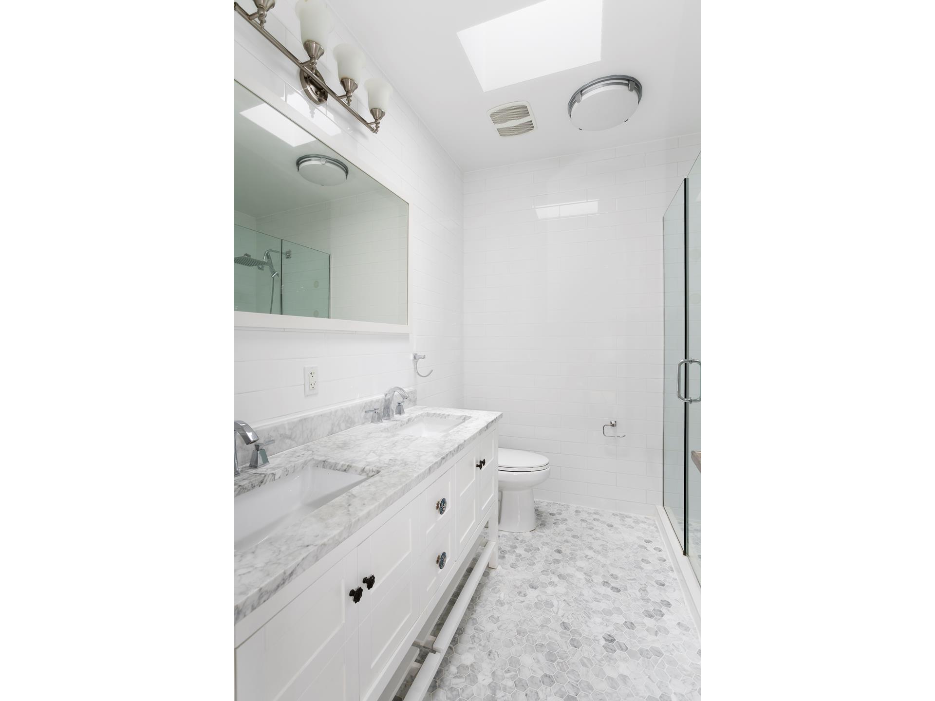 274 Eldert Street Brooklyn, NY 11207 - Photo 12 of 18 a en suite bathroom with a granite countertop sink and a mirror