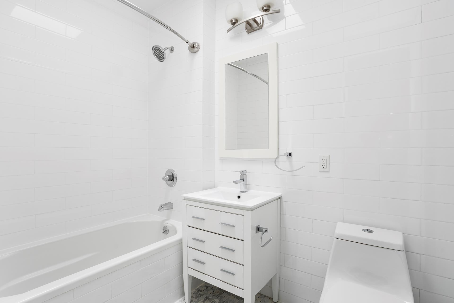 274 Eldert Street Brooklyn, NY 11207 - Photo 14 of 18 a bathroom with a sink toilet tub and vanity