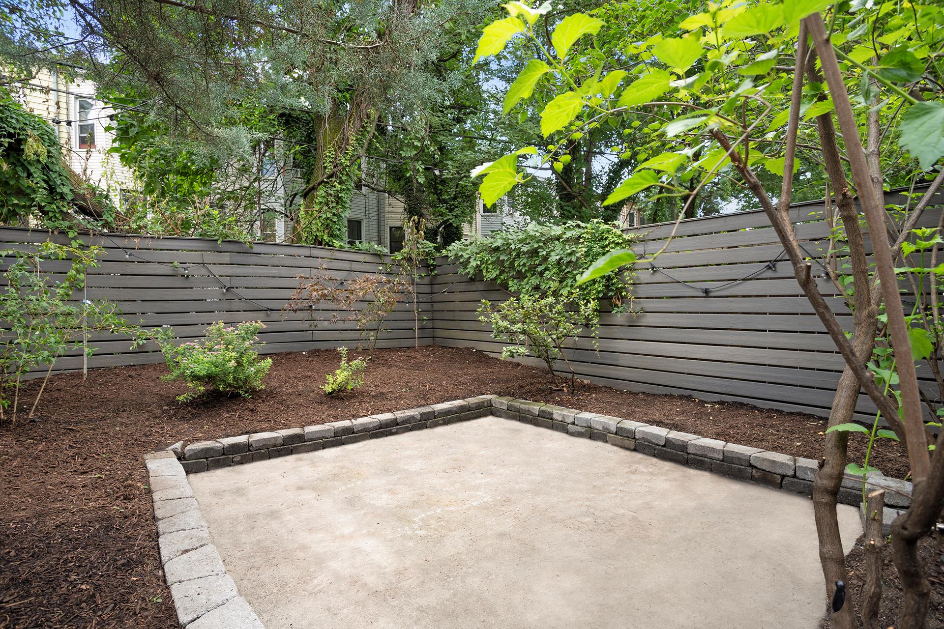 274 Eldert Street Brooklyn, NY 11207 - Photo 16 of 18 a backyard of a house with lots of green space