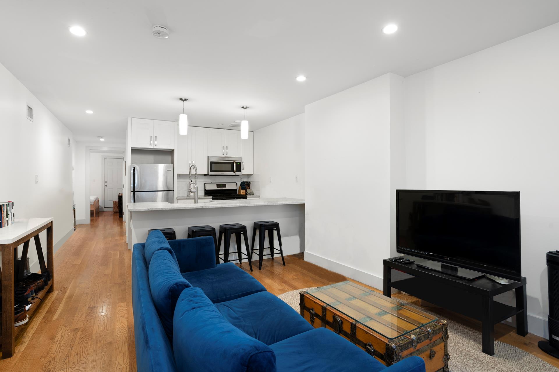 274 Eldert Street Brooklyn, NY 11207 - Photo 4 of 18 a living room with furniture and a flat screen tv