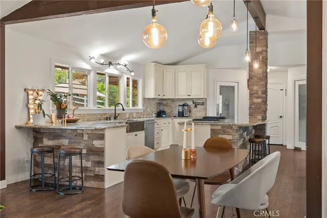 a bathroom with a granite countertop sink a mirror and a vanity