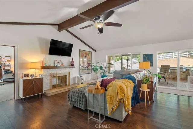 a bathroom with a granite countertop sink a toilet a mirror a vanity and bathtub