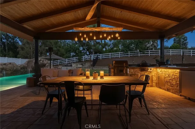 a living room with furniture a flat screen tv and a floor to ceiling window